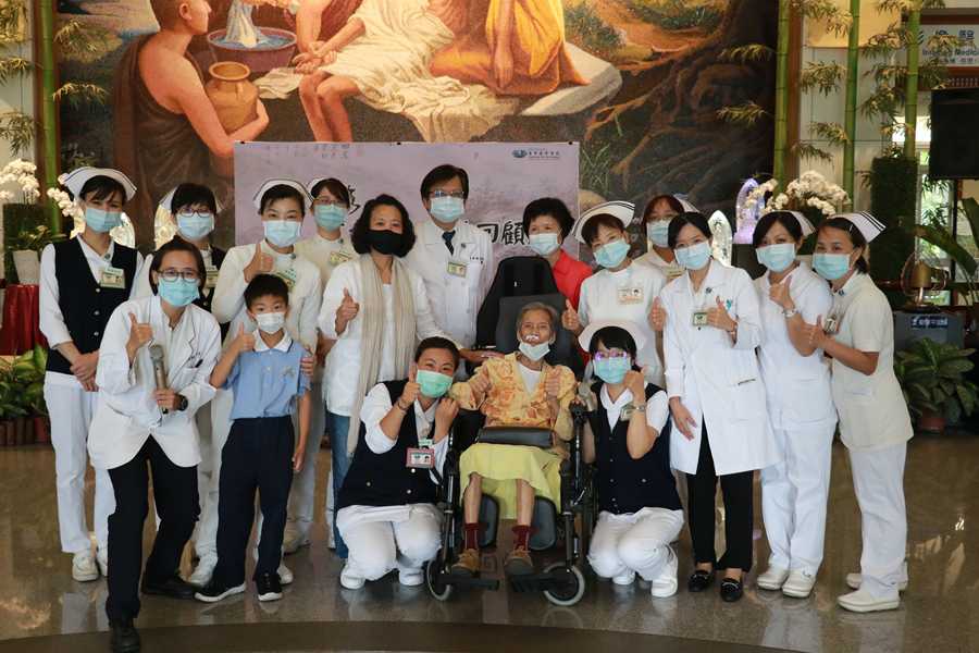 在醫護團隊熱情簇擁下，林阿梅個展會場留下溫馨又熱鬧合照。